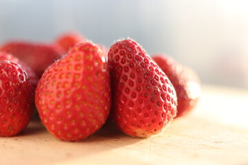 Strawberries on wooden chopping board