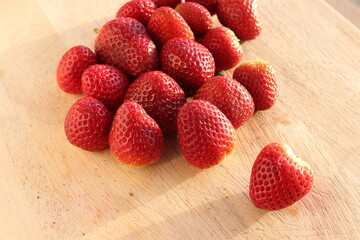 Strawberries on wooden chopping board