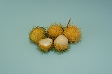 yellow rambutan fruits isolated on green background