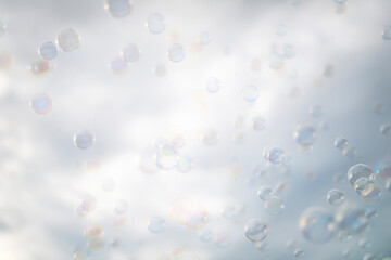 many soap bubbles on a cloud background