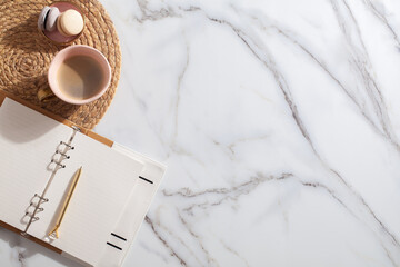 diary for the year 2021, pen, coffee, macaron cookie on straw woven placemat