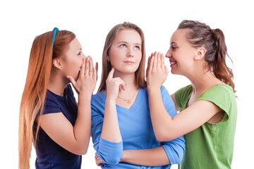 Three Young Positive Caucasian Girlfriends Sharing Their Secrets Whispering to Ears.Isolated Over White Background.