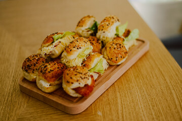 Small canapes sandwiches served on a plate at the celebration. Snack for guests