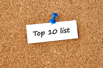 Top 10 list. Text written on a piece of paper, cork board background.