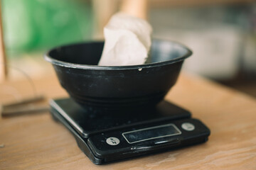 Weighting scales with the clay dough