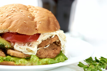 Simple commercial cake with chicken lettuce, tomato cheese and avocado, in the background a beet juice