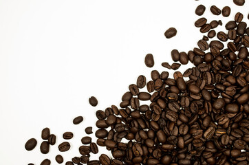 Roasted coffee beans against a white background.