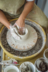Woman making pottery on the wheel