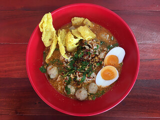 Spicy TOM YAM pork noodle soup with boiled eggs