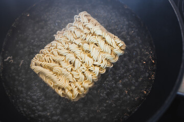 simple food ingredients, noodles cooking in pan on kitchen stove top