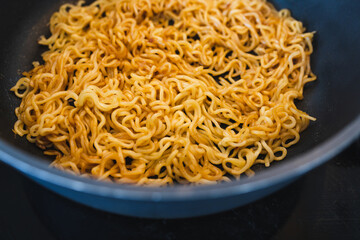 simple food ingredients, noodles cooking in pan on kitchen stove top