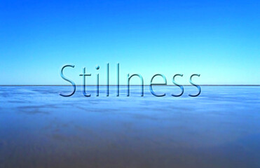 Coastal horizon with a clear blue sky reflected on shimmering beach with selective focus.