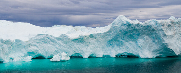 Global Warming and Climate Change - Icebergs and ice from melting glacier in icefjord in Ilulissat, Greenland. Aerial photo of arctic nature ice landscape. Unesco World Heritage Site. Panoramic banner © Maridav