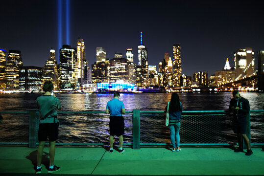 Sept 11, 2020 People taking pictures with  9/11 Memorial Lights at Brooklyn Bridge Park, New York City, USA.