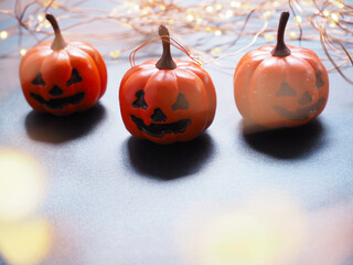 orange pumpkin head jack lantern on black texture for Halloween background.
