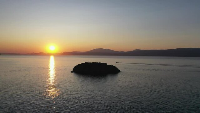 A small island in front of Vlychos Plakes Beach in Hydra Island, Greece