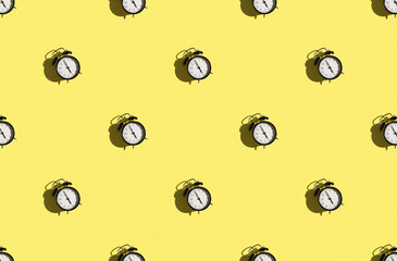 Trendy sunlight pattern made with black and white clock on light yellow background.