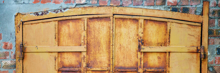 Old iron door in brick wall. Banner