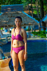 Obraz premium Woman with bikini stand relax on pool