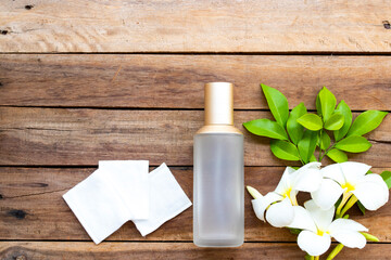 the therapy first serum toners with cotton natural cosmetics extract herbal health care for skin face beauty of woman and flower frangipani arrangement flat lay style on background wooden