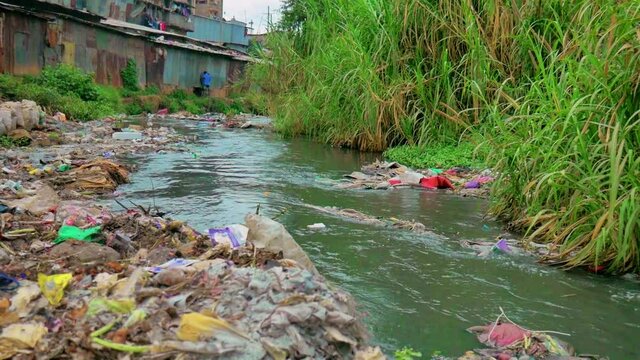 A river in an Mathare Slums located in Kenya, Africa, showing the pollution caused by improper waste management and climate change that has led to it being a hazardous place to be around.