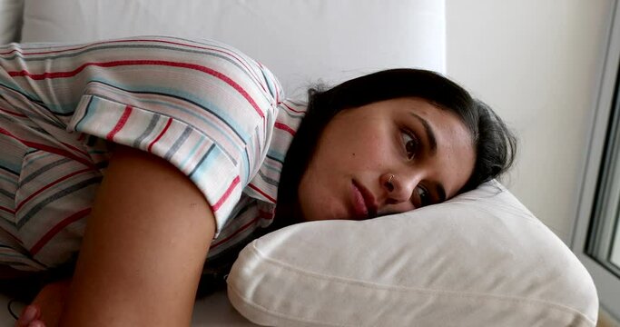 Tired girl slouches in sofa after a long day