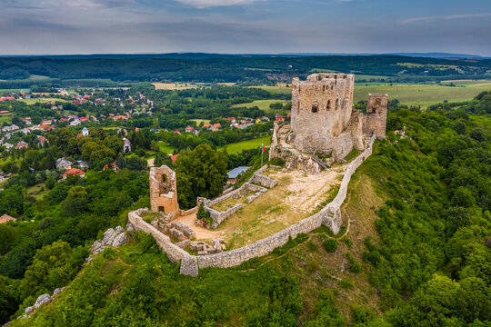 Csesznek, Hungary - Aerial panoramic view of the hilltop Castle of Csesznek and Csesznek city at sunset on a sunny summer afternoon