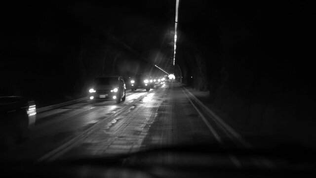 Gorgeous black and white clip of driving POV through a tunnel. Noir feel.
