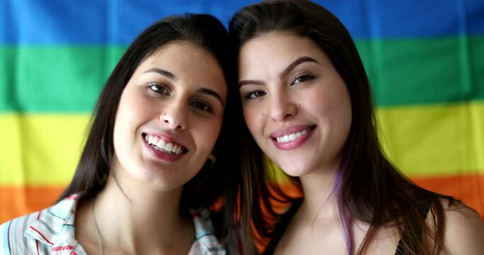Two LGBT young women smiling at camera
