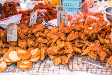 Deep fried chicken and sausage, Thai style fried chicken at the food market in northern Thailand