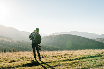 The daughter hug parent on nature. Dad with backpack and child walk in the autumn grass. Family...