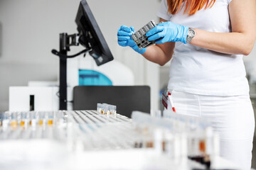 Lab assistant holding blood samples and checking if it is covid-19 positive.