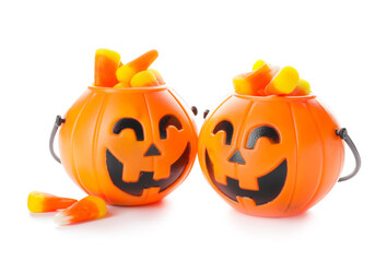 Baskets with tasty scary candies for Halloween on white background