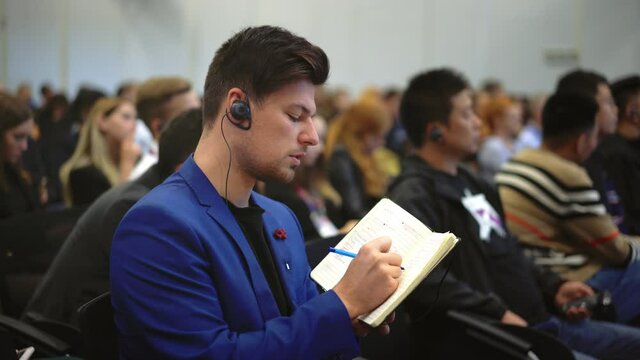 Crowd Student Study Forum Business Man Auditorium College. Education Audience Person Write Note. Studying Crowded Seminar Writing Notepad. Auditorium Group People Listen Educational Speech High School