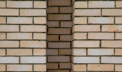 Horizontal detail shot of new brick wall with different depth for background. Beige texture