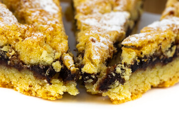 Tasty cake with powder sugar on top and plum stuff