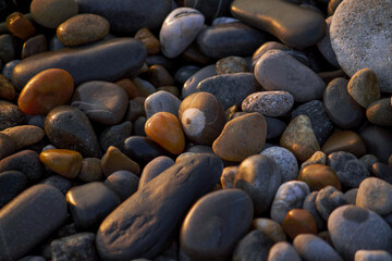 Stones on the beach in warm light of sun