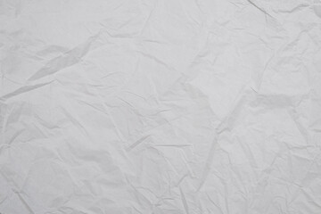 Crumpled white paper background.