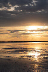 Golden sunset with colorful sky and colorful water in lake reflected in evening