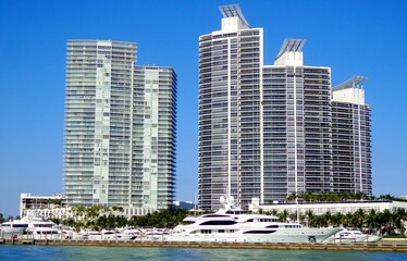 Fototapeta na wymiar Yachts docked at small port in front of Miami high-rises - Miami, Florida, USA 