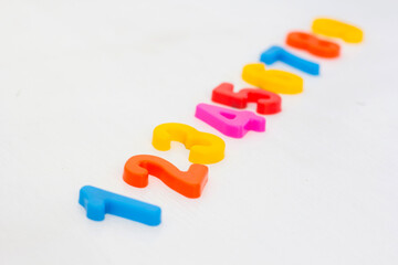 Naklejka premium Kids plastic numeral on white background. Study counting with fridge magnets. Education in preschool and primary school