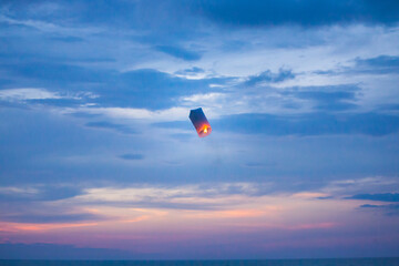 Floating lanterns in the evening sky.