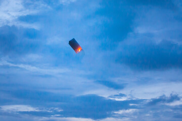 Floating lanterns in the evening sky.