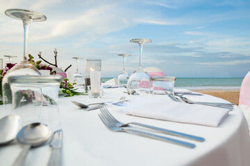 Set the table for dinner on the beach.