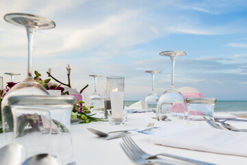 Set the table for dinner on the beach.