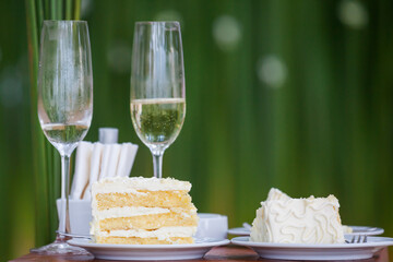 The wedding cake is cut into pieces.