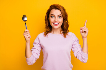 Portrait of excited crazy woman hold spoon decide healthcare dinner impressed raise index finger up...