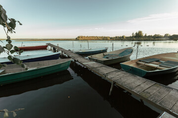 Fototapeta na wymiar Beautiful pier with fisherman's wooden boats at rest.