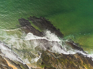 Aerial drone view on Fanore beach, county Clare, Ireland. Top down view, Stone rock coast line and ocean waves.