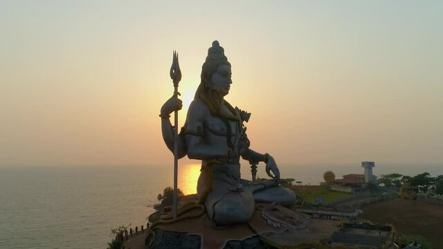 murudeshwar shiva statue drone shot by sea sunset behind south india drone